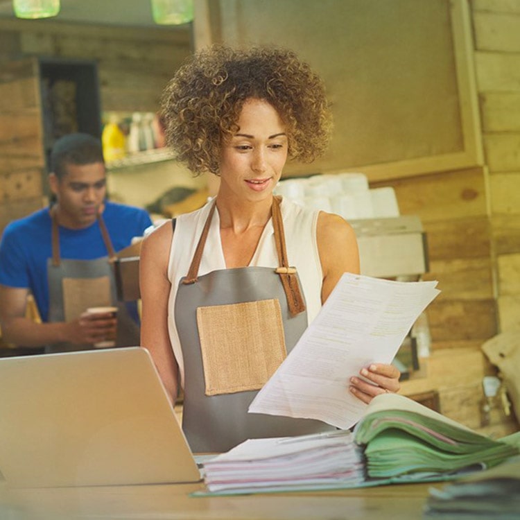 Woman looking at documents in an American warehouse Woman looking at documents in an American warehouse