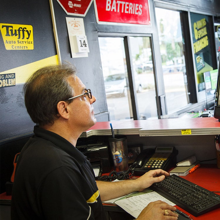 A man working behind a computer.