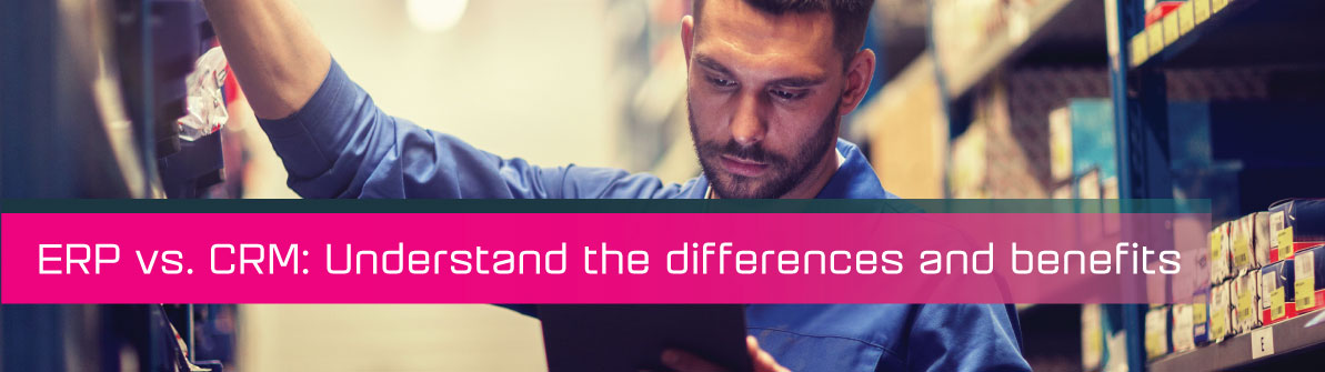 A man looking on an ipad in a warehouse.