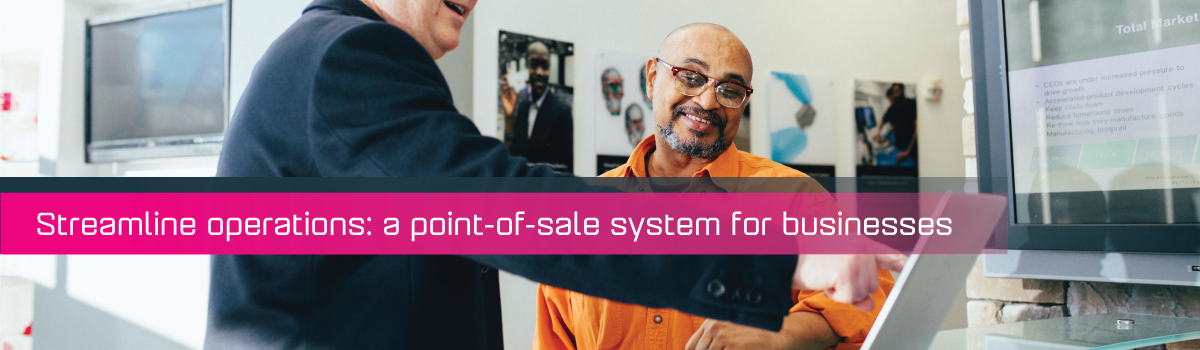 Two male individuals looking at a monitor